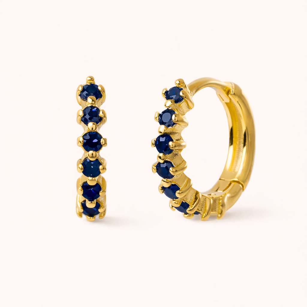 Retro Filter Earrings in gold with sapphire-blue crystals, showing the same five-stone graduated huggie hoop.
