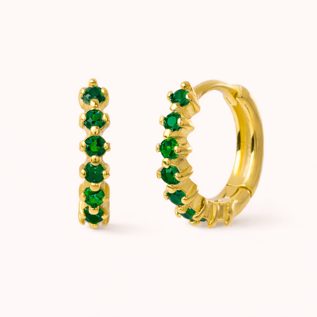 Retro Filter Earrings in gold with emerald-green crystals, the huggie hoop lined with five graduated round stones.