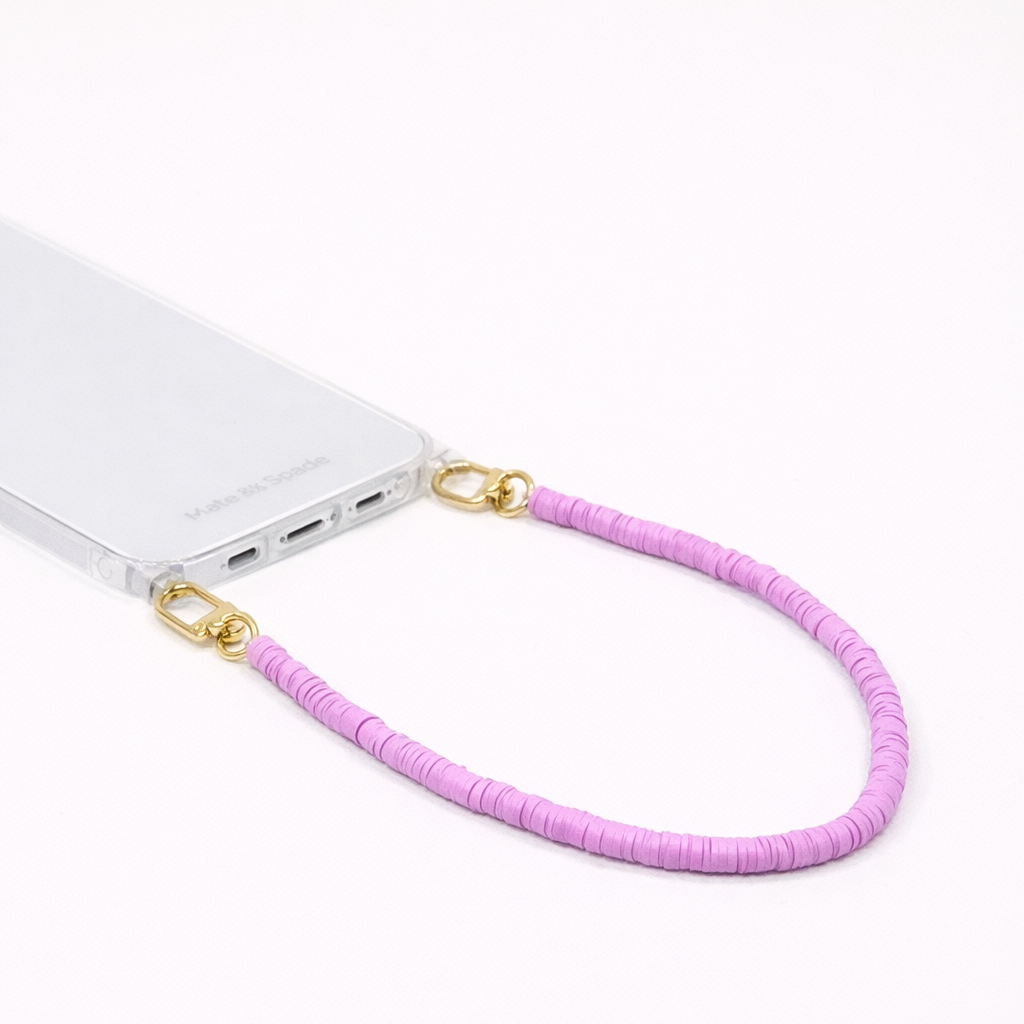 Lilac heishi bead Scottie SHORT PHONE CORD clipped to a clear phone case with gold hardware.