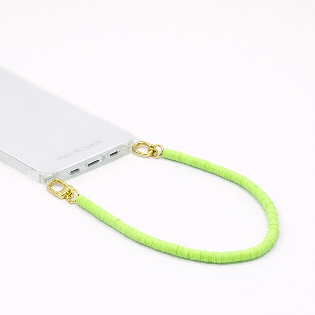 Lime green heishi bead Scottie SHORT PHONE CORD clipped to a clear phone case with gold hardware.