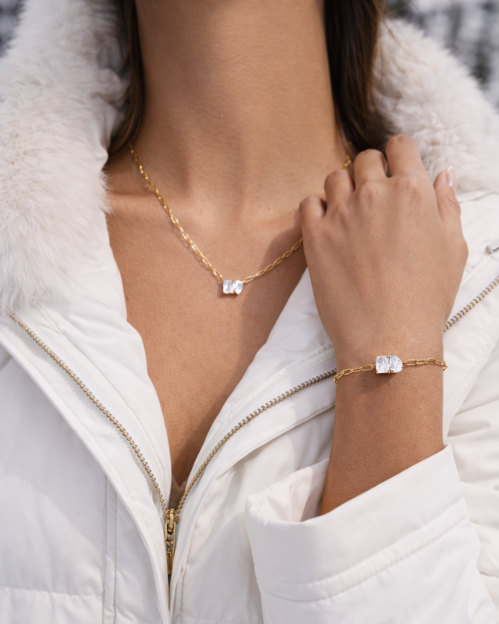 Sharp Halo BRACELET worn with the matching necklace, model in a white fur-trimmed coat against a snowy winter background.