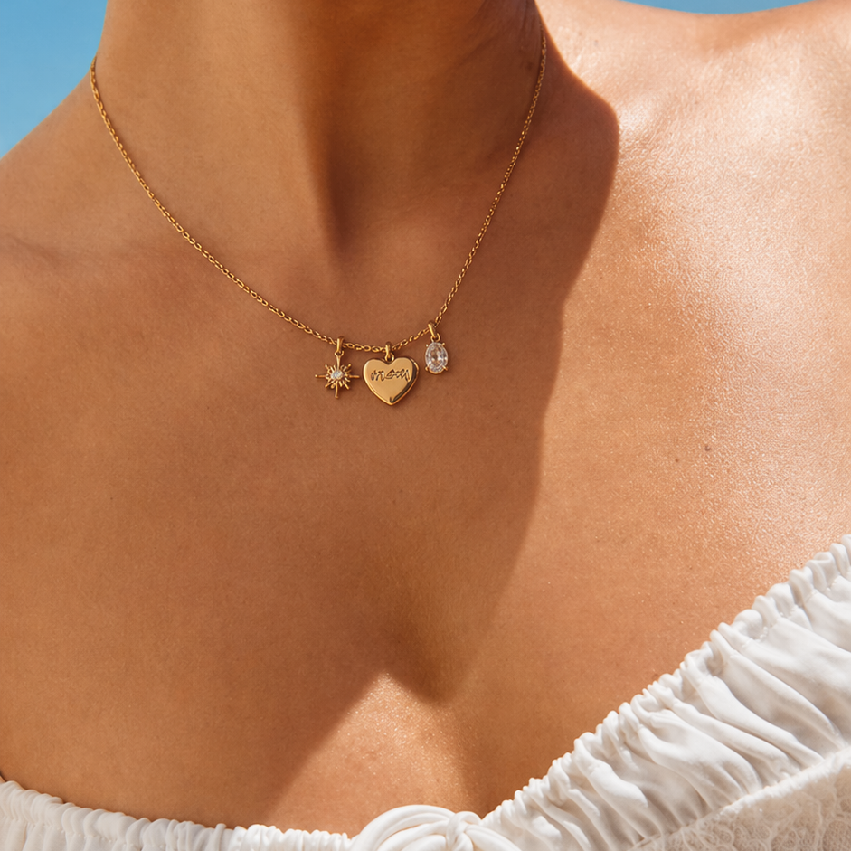 The Soft Power NECKLACE worn at the neckline with a white ruffled top, its star, heart, and crystal charms catching the sun.