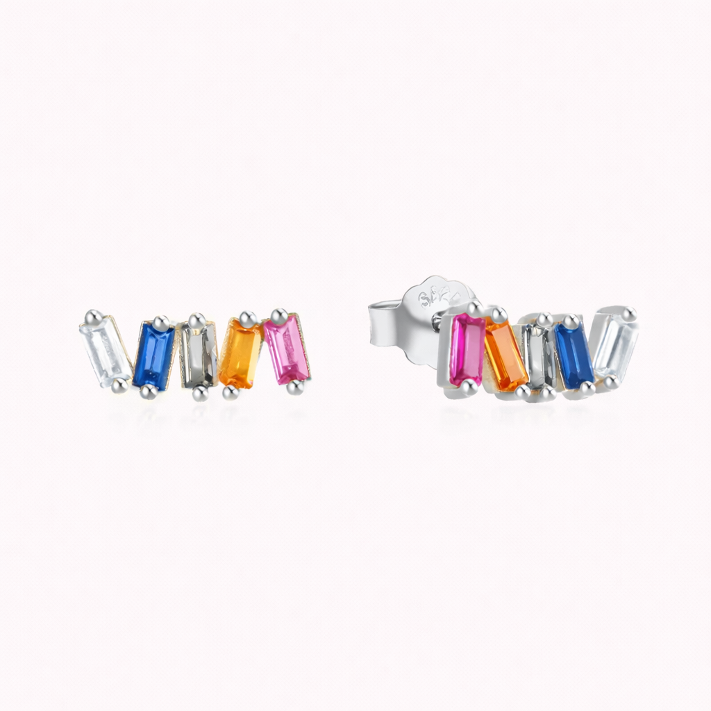 In silver tone, Solara Earrings arrange five baguette stones in white, blue, gray, orange, and pink along a curved row.
