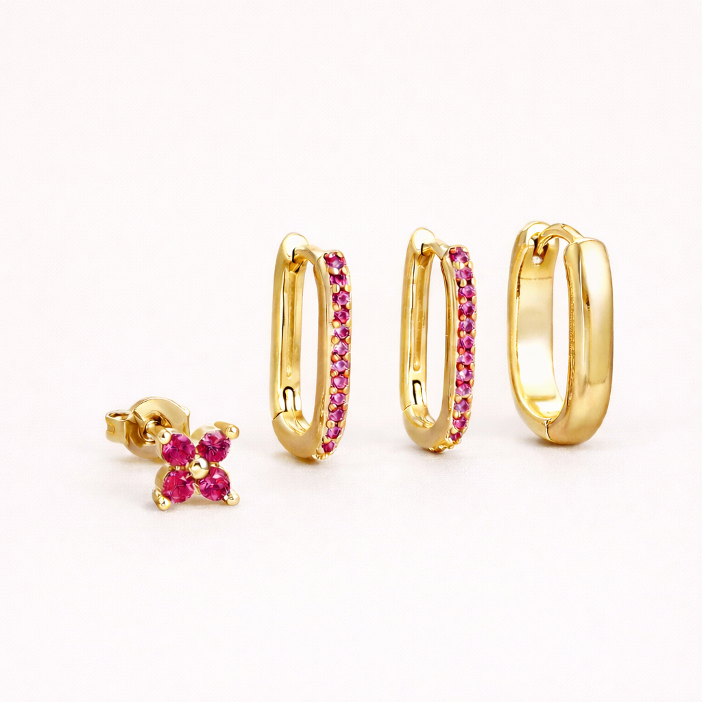 Sophia Set in gold with pink crystal accents, showing the same clover stud and crystal-lined rectangular hoop trio.