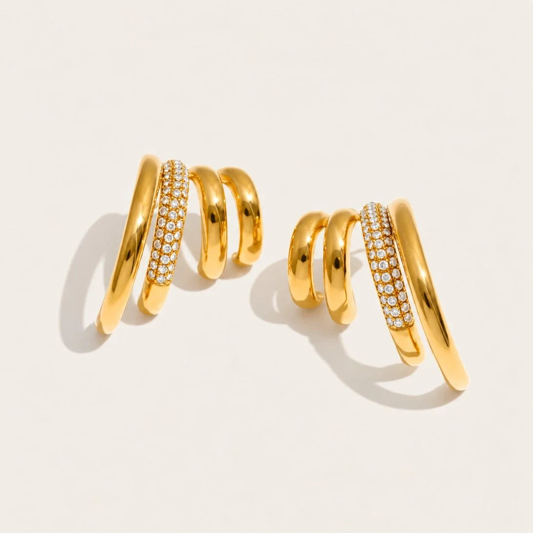 Gold Strata EARRINGS: a pair of earrings with three wavy layers, one row set with pavé white zirconia — Folie à Trois