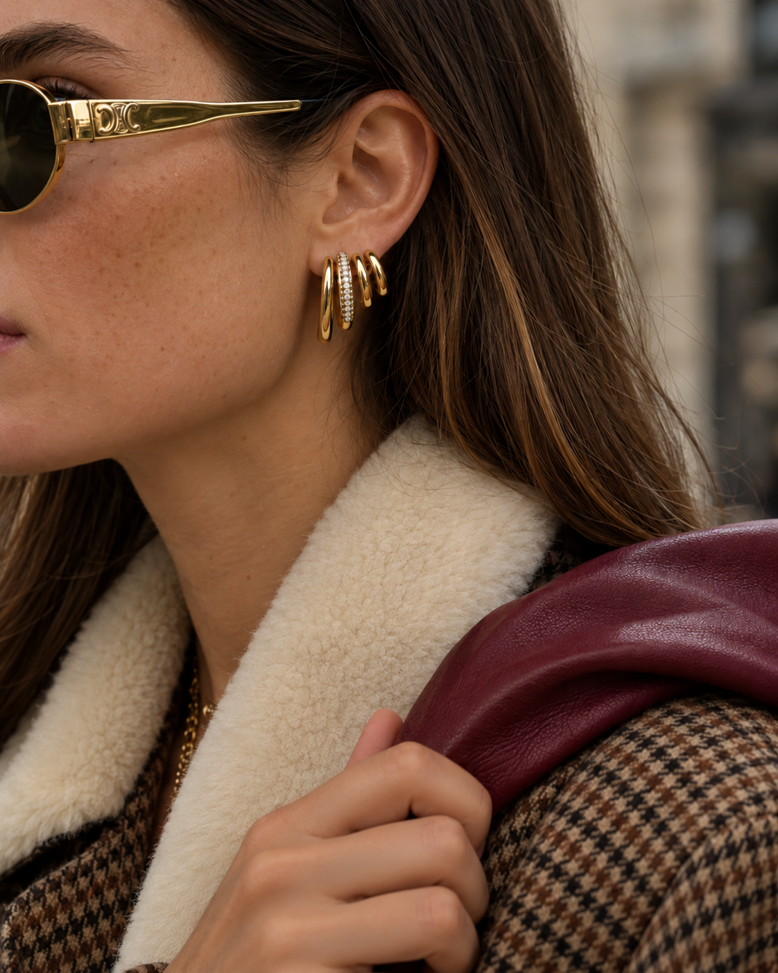 Gold Strata EARRINGS with three pavé lines worn with sunglasses, a shearling collar and burgundy bag — Folie à Trois