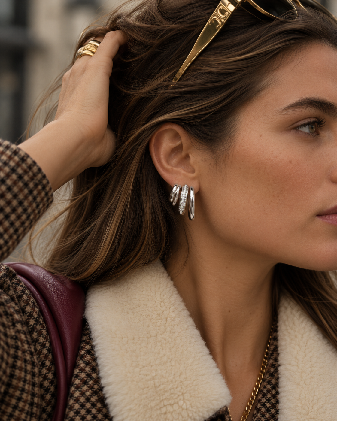 Silver-tone Strata EARRINGS with three sparkling pavé lines on a woman in a houndstooth coat with cream shearling collar