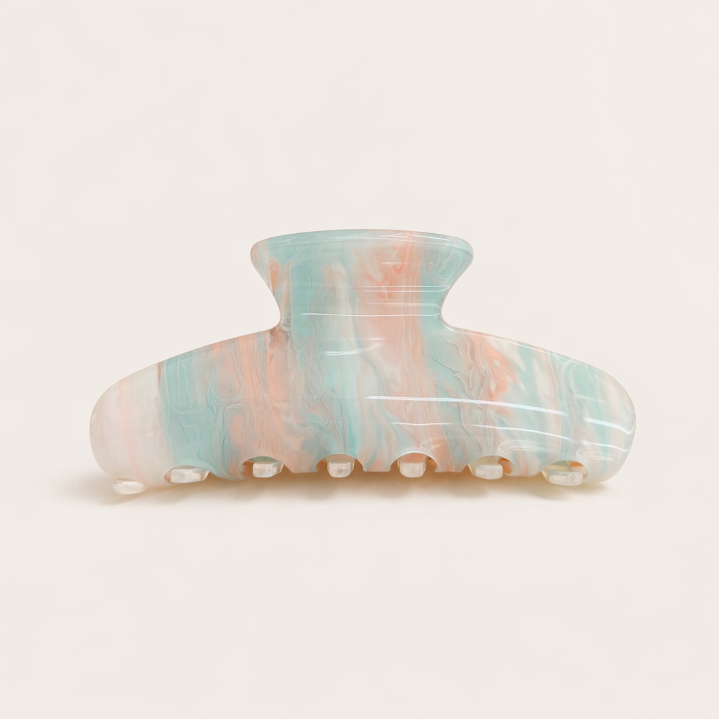 Sundae HAIR CLIP wave-shaped acetate claw clip in a pastel blue, pink and peach marbled pattern, studio shot.