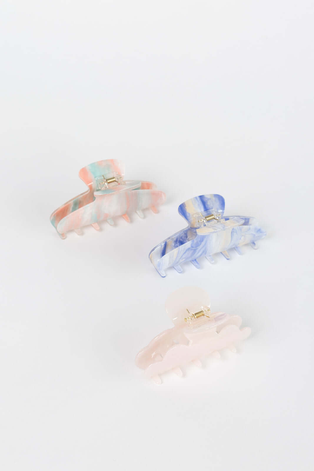 Sundae HAIR CLIP three claw clips shown together in peach-mint, blue-cream and solid pink pearl colorways, studio shot.