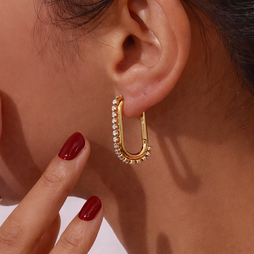 Sweet Thing Earring worn on the ear in gold, the crystal-lined oblong hoop catching the light nicely.