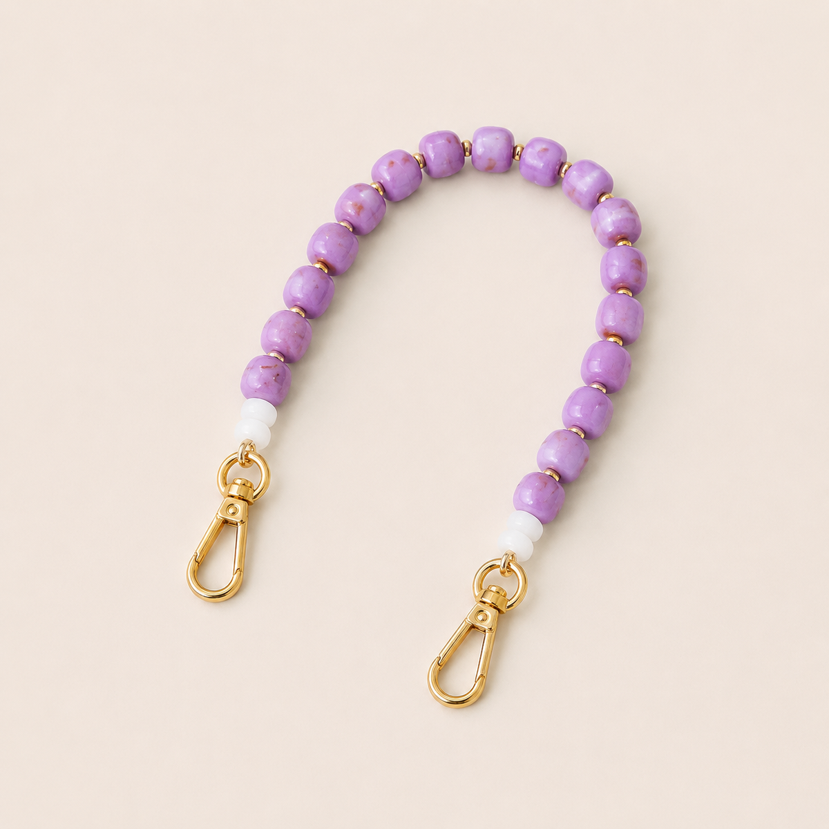 Lavender bead phone chain with white spacers and gold clasps on cream — Folie à Trois Teagan wholesale phone chain