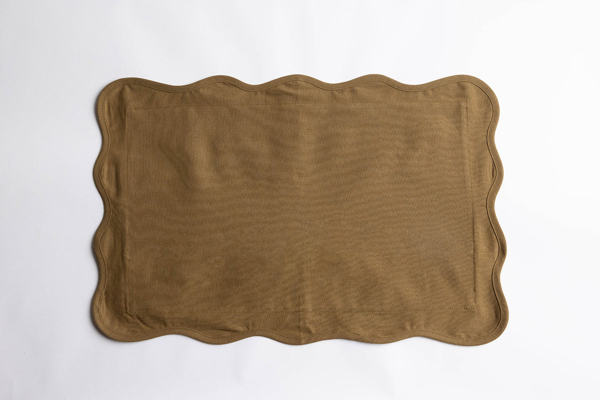 Flat lay of the Terry Rectangle Linen cushion in khaki-olive linen with a wavy scalloped edge on a plain white background.
