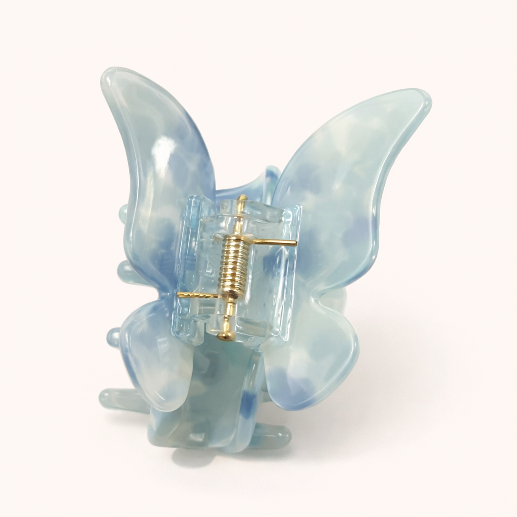 Blue and white marbled layered acetate butterfly-shaped claw clip from the True Paradise HAIR CLIP collection.