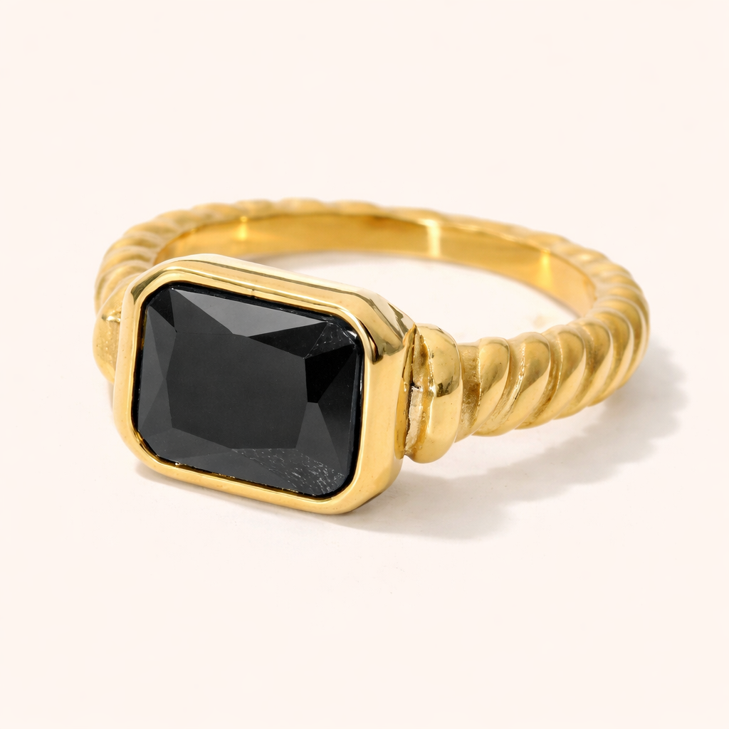 Vintage Vibes RING in gold with a rectangular black stone set in a twisted rope-style band, shown in a studio close-up.