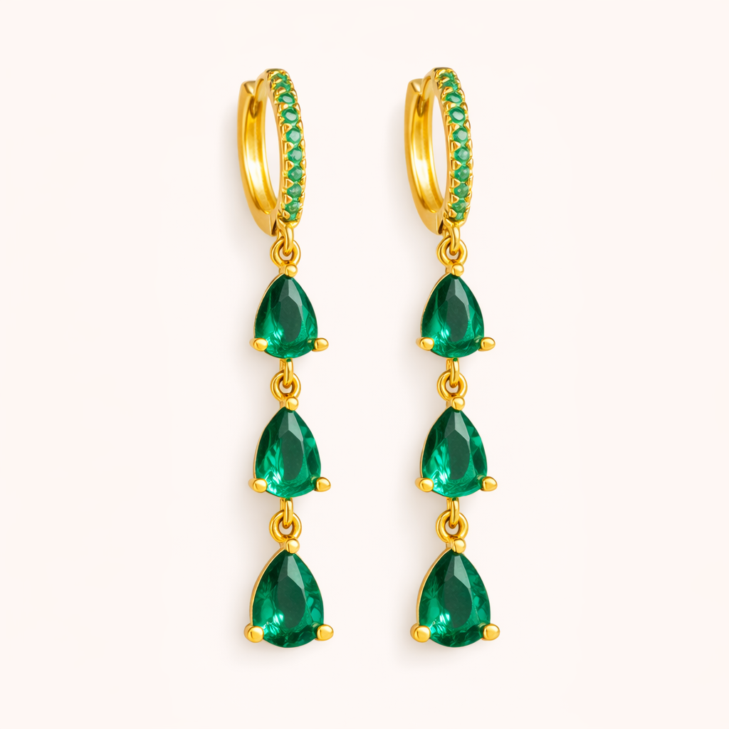 Waterfall Earrings in gold with emerald-green crystals, the pave hoop dropping three graduated teardrop stones.