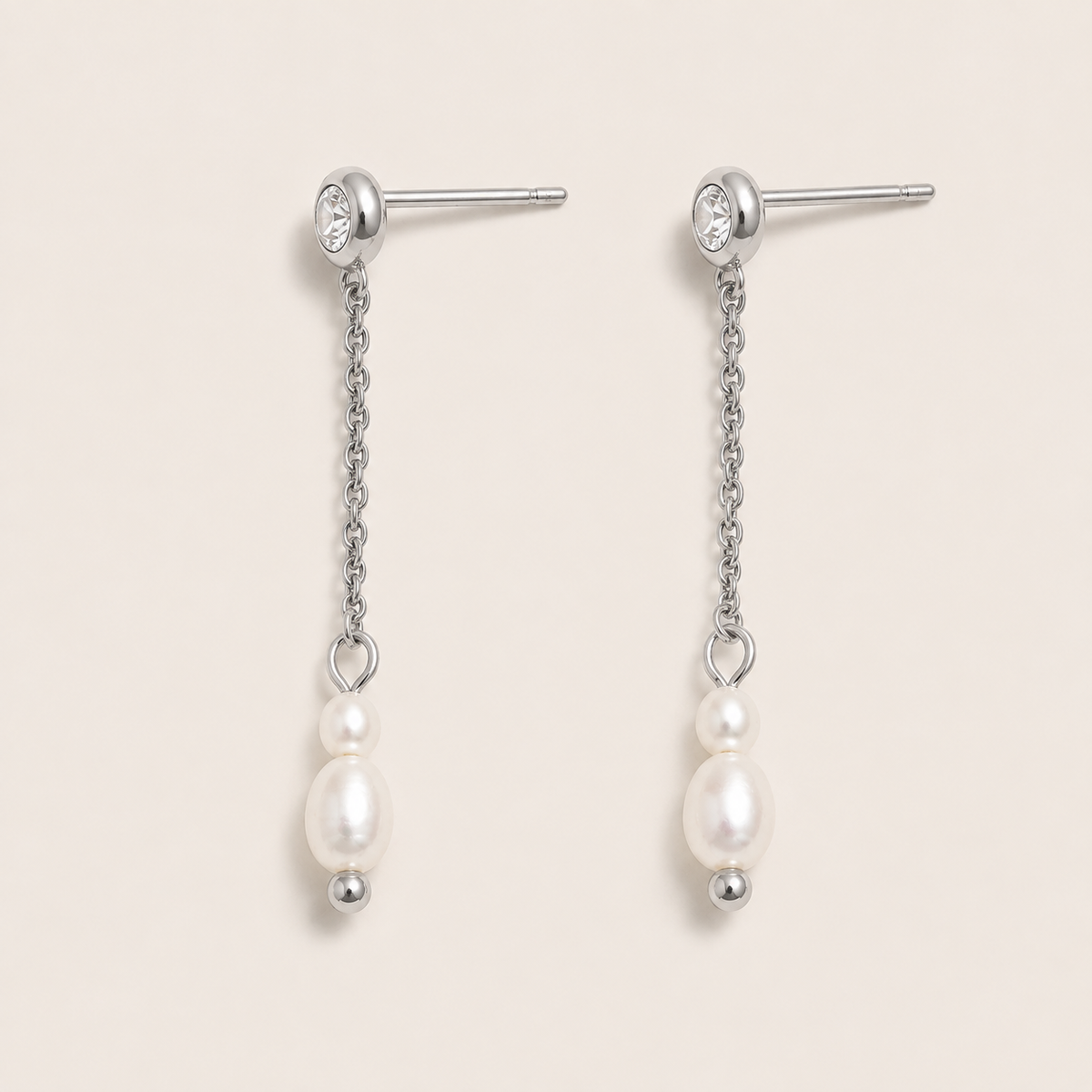 Silver drop earrings with a zirconia stud, fine chain and two graduated pearls on a cream backdrop — Folie à Trois Whisper EARRINGS