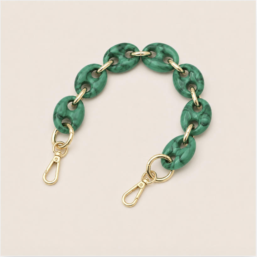 Folie à Trois Wilder short phone chain in green marbled puffed links with gold connectors, laid flat on a cream background.