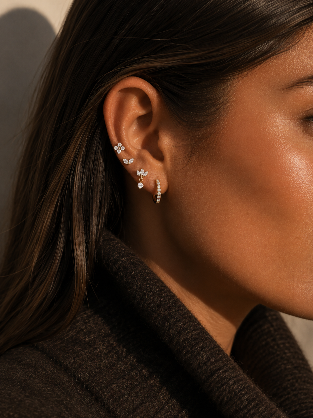 Model wears the Folie à Trois Willow SET stacked along the ear, a flower stud layered with marquise studs and a pavé hoop.