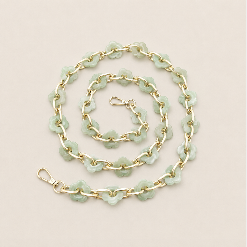 Coiled flower-link phone chain in sage green acrylic with gold chain links on cream — Folie à Trois Zinnia long phone chain