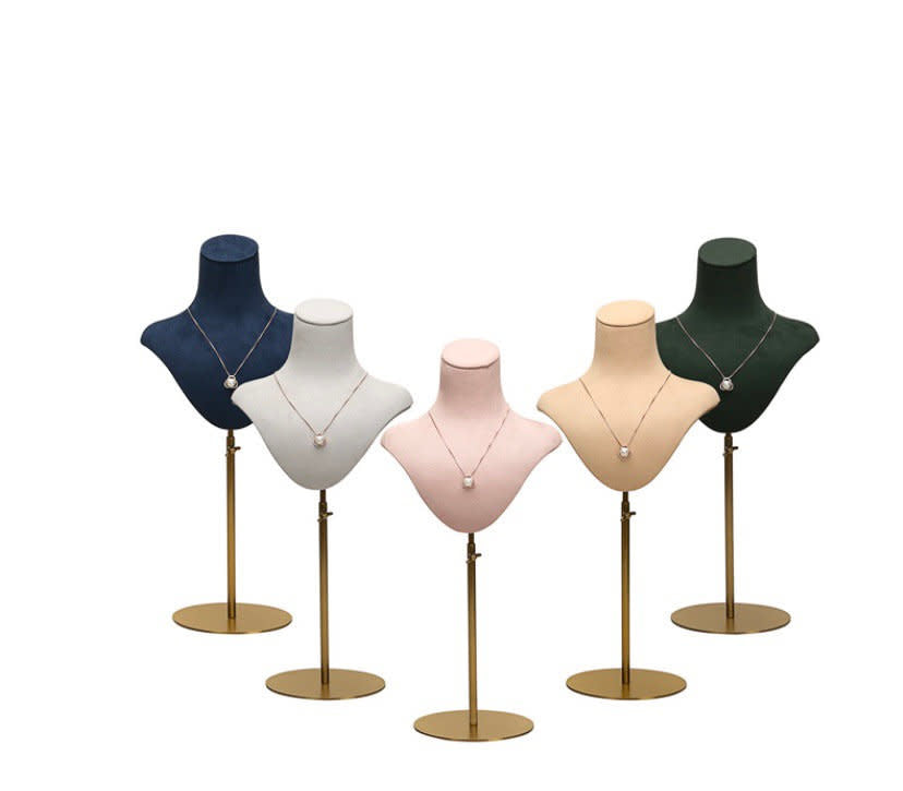 Mannequin Velvet DISPLAY in five colors, navy, white, pink, beige and green velvet busts on gold stands with necklaces.