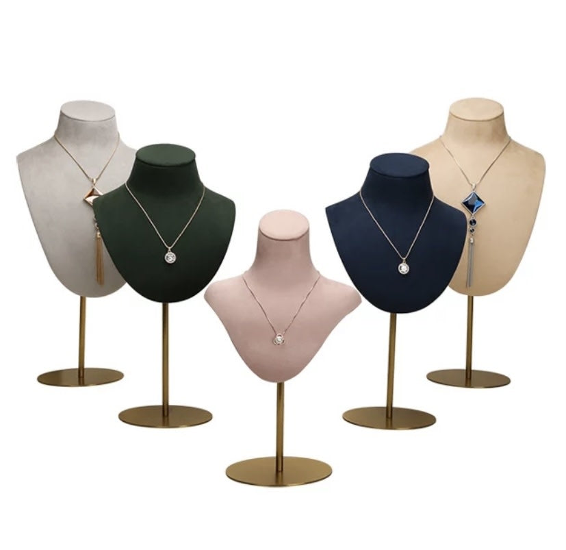 Five Mannequin Velvet DISPLAY busts in white, green, pink, navy and beige velvet on gold stands, each with a necklace.